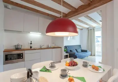 a kitchen with a table with a bowl of fruit on it at Central Verdete in Barcelona