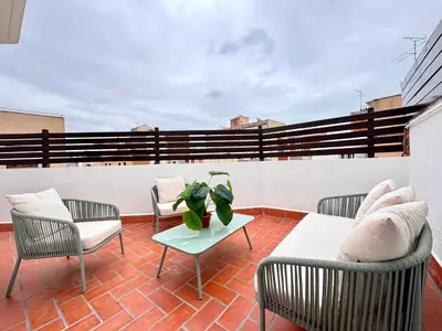 a patio with chairs and a table on a roof at Crysoyle Apartment II Barcelona Next to Camp Nou in Hospitalet de Llobregat