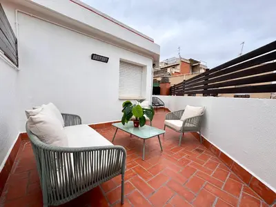 a balcony with chairs and a table on a building at Crysoyle Apartment II Barcelona Next to Camp Nou in Hospitalet de Llobregat