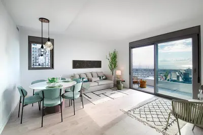 a living room with a table and chairs and a couch at Seaside Badalona Apartment in Badalona