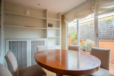 a dining room with a wooden table and chairs at BALMES - Atico con terraza en Sant Gervasi in Barcelona