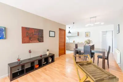 a living room with a table and a dining room at Casa Mar Blava con piscina comunitaria junto Barcelona Centro in Alella