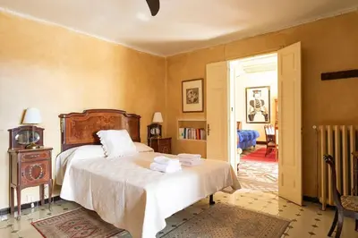 a bedroom with a large bed with white sheets at Casa Victor Riu in Piera