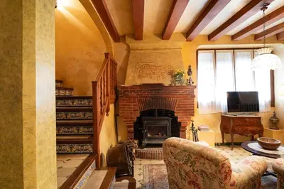 a living room with a fireplace and a television at Casa Victor Riu in Piera
