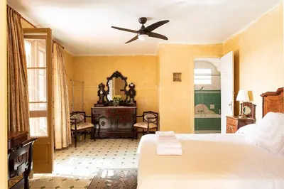 a bedroom with a bed and a ceiling fan at Casa Victor Riu in Piera