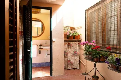 a bathroom with a sink and a mirror and flowers at Casa Victor Riu in Piera