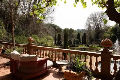 a patio with chairs and a fence and a fountain at Casa Victor Riu in Piera
