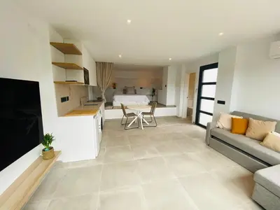 a living room with a couch and a table at Pandi's Place in Sant Pere de Ribes
