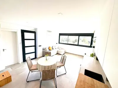 a living room with a table and chairs at Pandi's Place in Sant Pere de Ribes