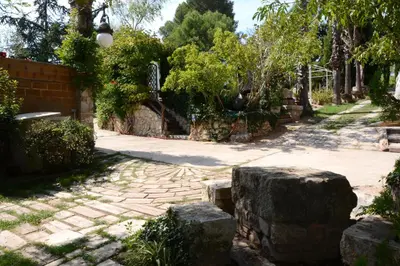 a garden with a stone pathway and trees at El Recer in Sant Pau dʼOrdal