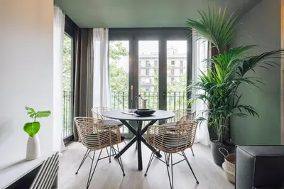 a shelf with books and a candle and a fan at Tagbu - 2 bedroom and balcony in Eixample Dreta in Barcelona