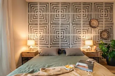 a bedroom with a large bed with a wooden frame at Lulua - 2 bedrooms in Eixample Dreta in Barcelona