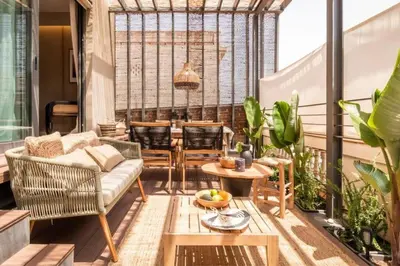 a balcony with two chairs and a wooden fence at Lulua - 2 bedrooms in Eixample Dreta in Barcelona