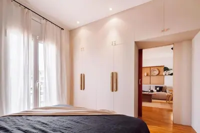 a living room with a table and a dining room at Yulu - 3 bedrooms and balcony in Eixample Dreta in Barcelona