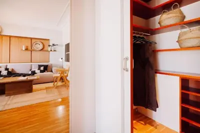 a living room with a potted plant and a television at Yulu - 3 bedrooms and balcony in Eixample Dreta in Barcelona