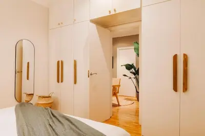 a bedroom with white cabinets and a bed at Yulu - 3 bedrooms and balcony in Eixample Dreta in Barcelona