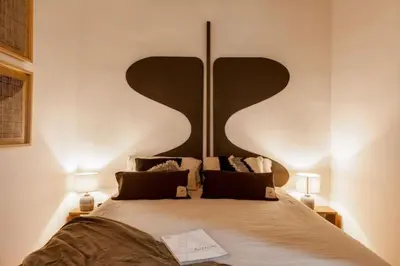 a bedroom with two beds and a mirror at Kakwa - 2 bedroom and balcony Eixample Esquerra in Barcelona