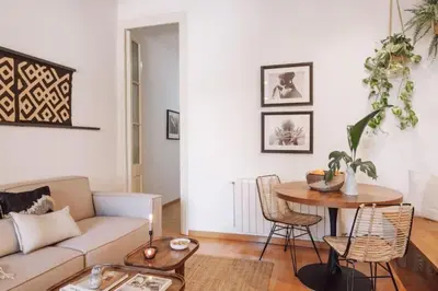 a living room with a washing machine and a couch at Kakwa - 2 bedroom and balcony Eixample Esquerra in Barcelona
