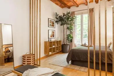 a bedroom with a bed and a large window at Kakwa - 2 bedroom and balcony Eixample Esquerra in Barcelona