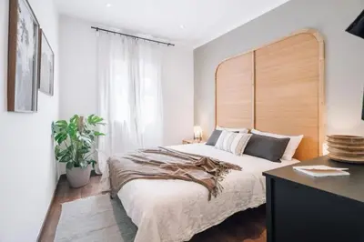 a bedroom with a bed and a desk and a table at Bolia - 2 bedrooms in Eixample Esquerra in Barcelona