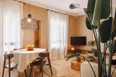 a living room with glass doors and a table at Baka - 2 bedroom with terrace in Sant Gervasi in Barcelona