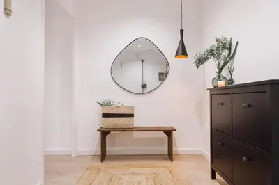 a hallway with white walls and a long hallway with paintings at Baka - 2 bedroom with terrace in Sant Gervasi in Barcelona