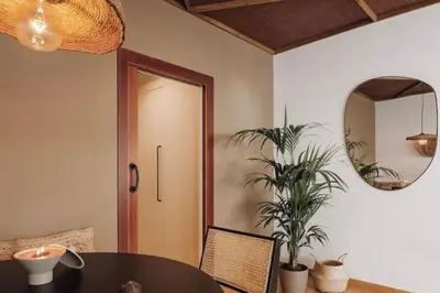 a bedroom with a bed and a potted plant at Babinga - 3 bedroom and balcony in Eixample Esquerra in Barcelona
