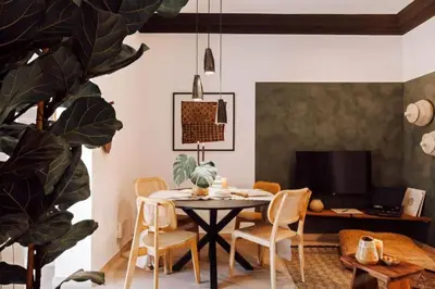 a pendant light hanging over a table with a plant at Hemba - 3 bedroom and balcony in Gracia in Barcelona