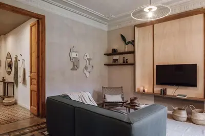 a living room with a flat screen tv on a wall at Ulindi - 2 bedroom with balcony in Eixample Esquerra in Barcelona