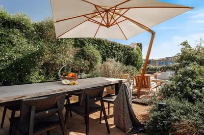 a dining room with a wooden table and chairs at Pende - 1 bedroom and swimming pool in Passeig de Gracia in Barcelona