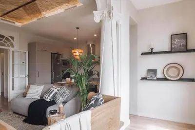 a living room with a couch in front of a window at Sanga - 2 bedroom in Eixample Esquerra in Barcelona
