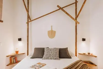 a bedroom with a large bed with wooden beams at Sanga - 2 bedroom in Eixample Esquerra in Barcelona