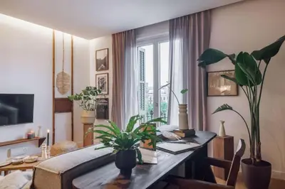 a living room with a couch and a table at Bemba - 1 bedroom and swimming pool in Passeig de Gracia in Barcelona