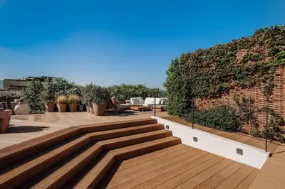 a living room with a gray couch with orange pillows at Bemba - 1 bedroom and swimming pool in Passeig de Gracia in Barcelona