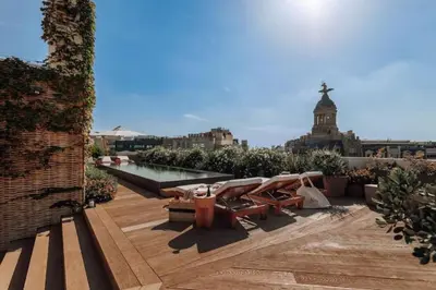 a patio with a bunch of chairs and trees at Bemba - 1 bedroom and swimming pool in Passeig de Gracia in Barcelona