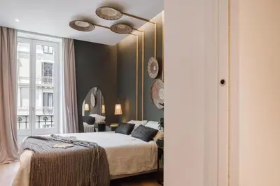 a bedroom with a large bed and a hallway at Kele - 1 bedroom and swimming pool in Passeig de Gracia in Barcelona