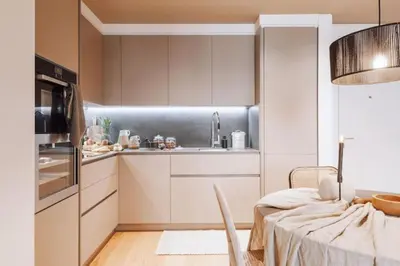a living room with a table and chairs and a living room at Kele - 1 bedroom and swimming pool in Passeig de Gracia in Barcelona