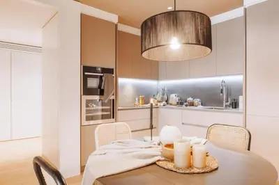 a kitchen with a table and a dining room at Kele - 1 bedroom and swimming pool in Passeig de Gracia in Barcelona