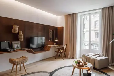 a kitchen with white cabinets and a table with a dining room at Kele - 1 bedroom and swimming pool in Passeig de Gracia in Barcelona