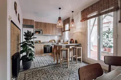 a bedroom with a black bed in a white room at Mwitu - 2 bedroom and balcony in Poblenou in Barcelona