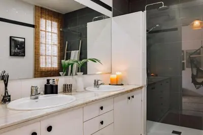 a kitchen with a white refrigerator and a table and stools at Mwitu - 2 bedroom and balcony in Poblenou in Barcelona
