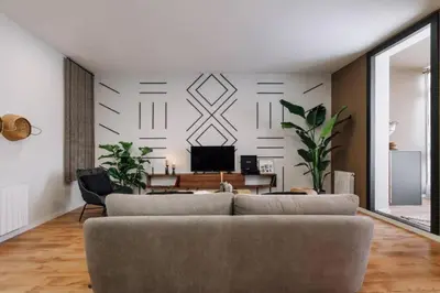 a white bedroom with a bed with a mirror at Luiza - 3 bedroom in Eixample Dreta in Barcelona