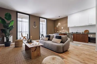 a bedroom with a large bed with two tables and two lamps at Luiza - 3 bedroom in Eixample Dreta in Barcelona