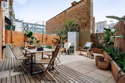 a patio with a table and chairs on a balcony at Matadi - one bedroom and terrace in Eixample Esquerra in Barcelona