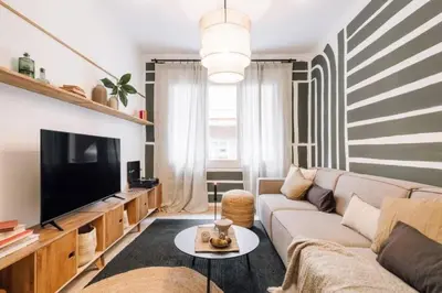 a living room with a couch and a tv at Kananga - 3 bedroom in Gracia in Barcelona