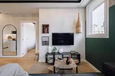 a kitchen with a blue counter and two stools at Batwa - 1 bedroom in Passeig de Gracia in Barcelona