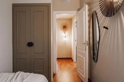 a bedroom with a large bed and two windows at Zamba - 2 bedroom in Passeig de Gracia in Barcelona
