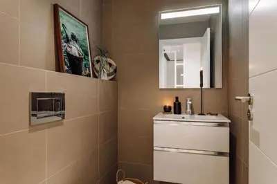 a living room with a desk with a television at Lega - 2 bedroom in Passeig de Gracia in Barcelona