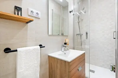 a bathroom with a sink and a shower at Lodging Apartments Almirall Beach 11 in Barcelona