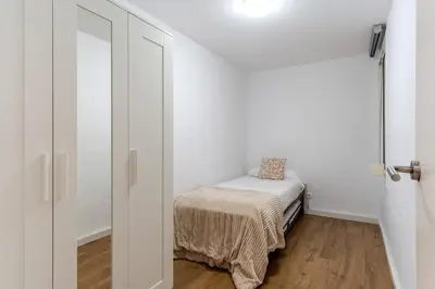 a small room with a small bed and a door at 2124 - AB Poblenou Beach Comfort in Barcelona